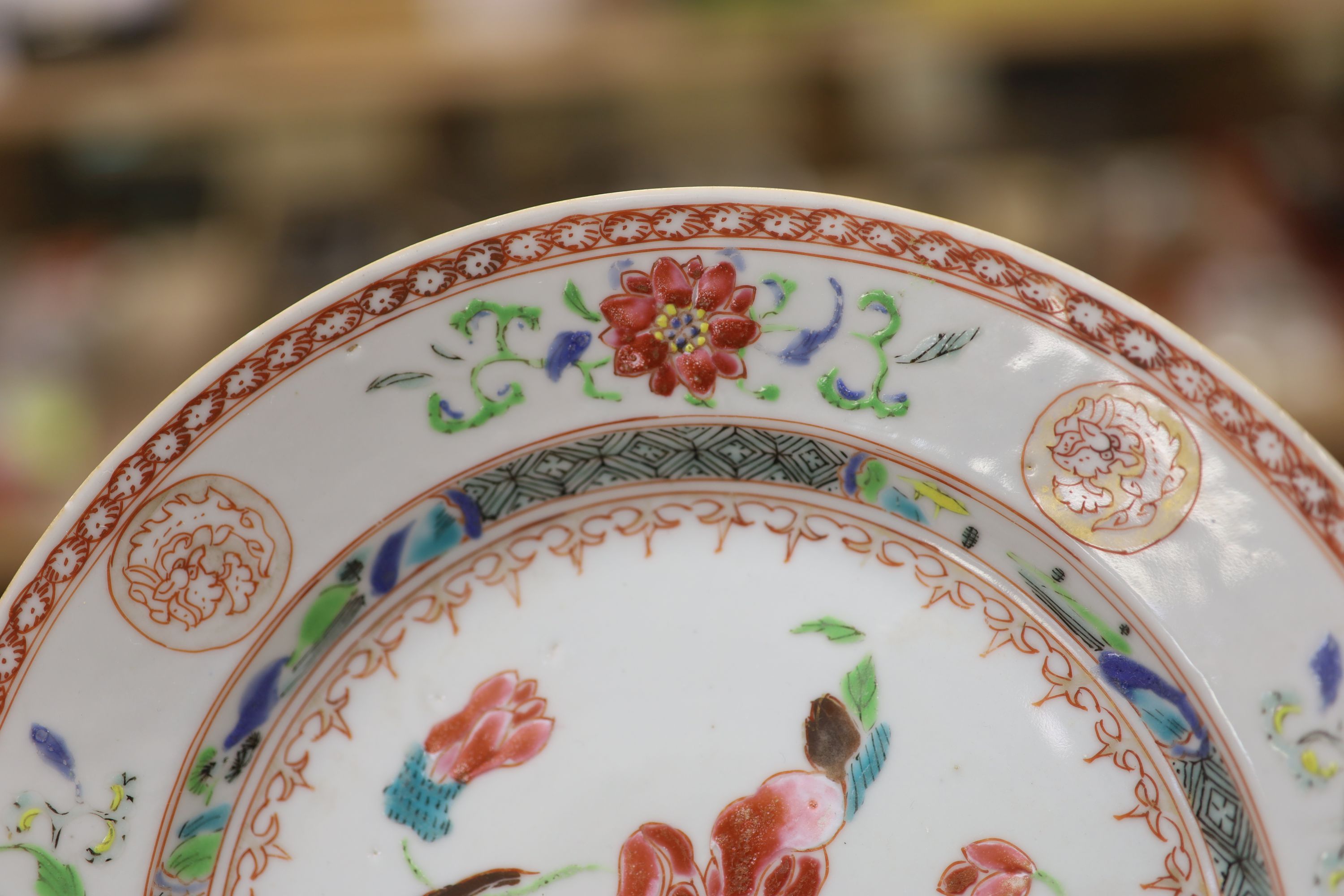 A pair of 18th century Chinese famille rose plates and another similar, largest diameter 22.5cm (damage)
